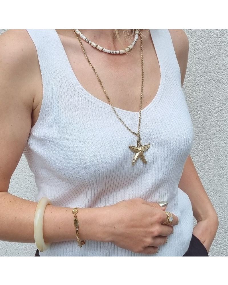 Collier sautoir étoile de mer doré MILE MILA porté avec un débardeur blanc – bijou en acier inoxydable tendance été 2025