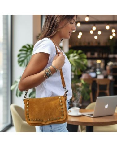 Femme portant un sac en daim camel Zosha Collection, look bohème chic avec jean et t-shirt blanc, accessoire mode tendance 2025
