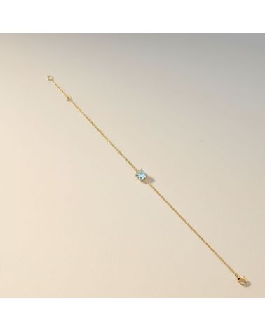 bracelet fin chaine plaqué or 18 carats avec pierre facette teintée couleur aigue marine
